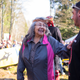 Will George (right) welcomes a visitor to the watch house with protestors from the March 10 march in the background.
